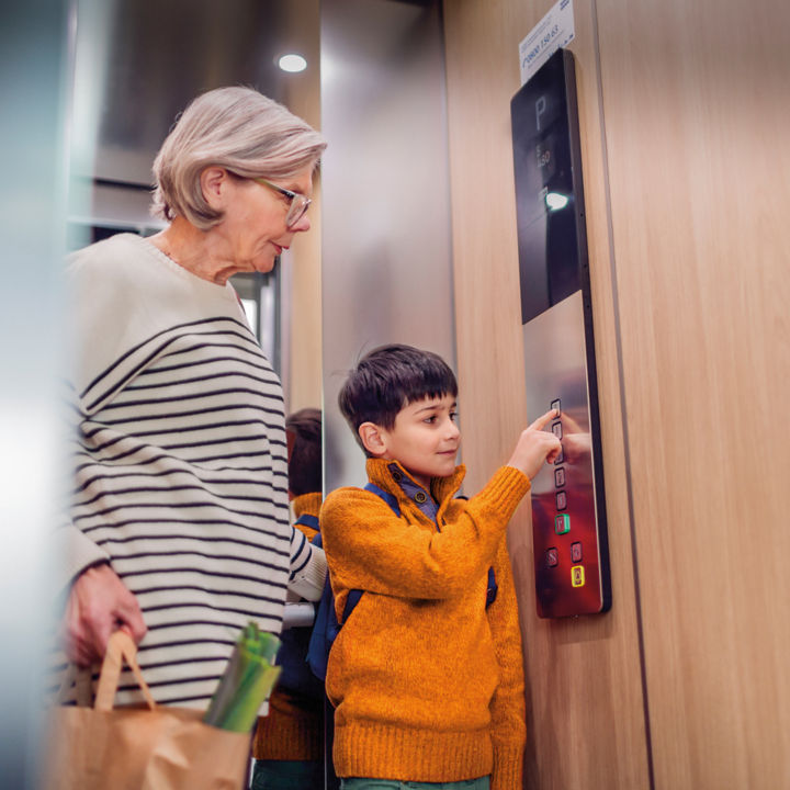 Elderly woman and boy KONE elevator